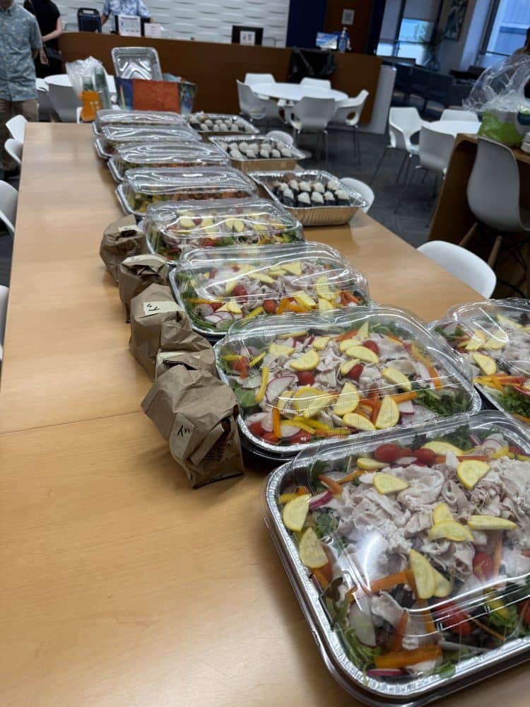 Catering trays lined up on a long table